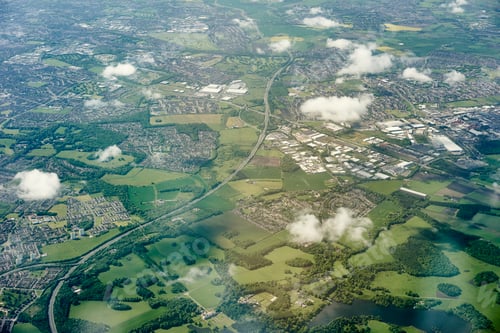 Preview: Aerial view of green fields and motorway, England, UK