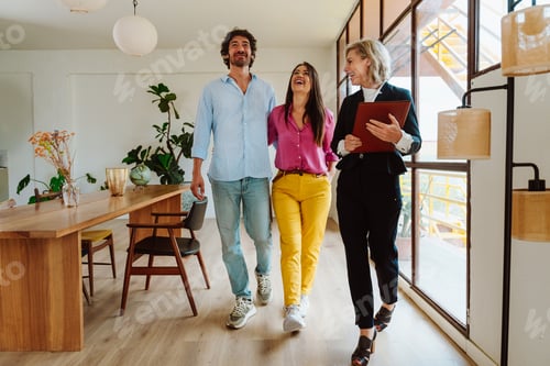 Preview: Real estate agent showing an apartment to a couple.