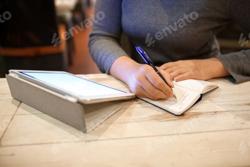Preview: Woman taking down information in notebook