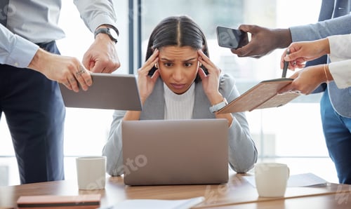 Preview: Shot of a young businesswoman feeling stressed out in a demanding office environment at work