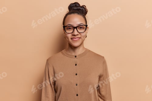 Preview: Portrait of pretty schoolgirl pleased to have summer holidays at last wears transparant eyeglasses