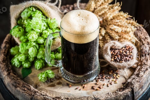 Preview: Cold dark beer with big foam, wheat and hops