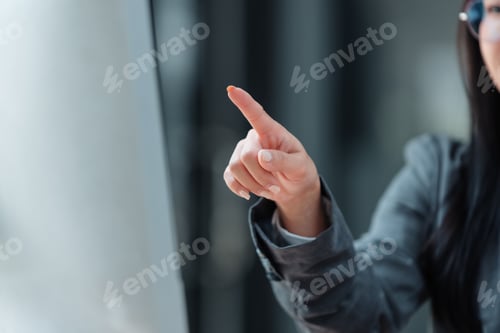 Preview: Businesswoman pointing with finger on blurred background