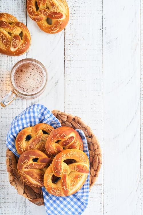 Preview: Bavarian pretzels and glass of lager beer. Oktoberfest food menu, traditional salted pretzels over o