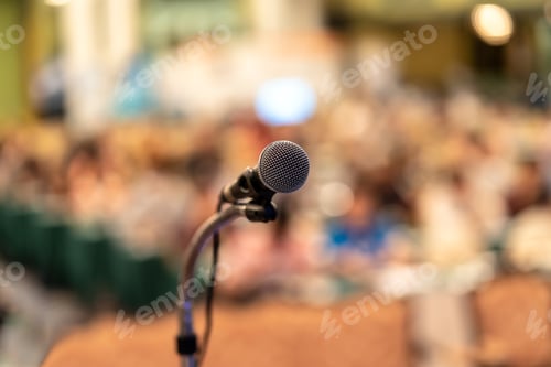 Preview: Microphone over the Abstract blurred photo of conference hall or seminar room with audience