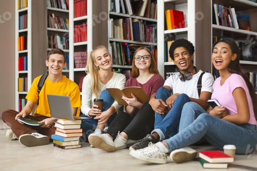 Preview: Group of diverse teenage classmates sitting on library floor