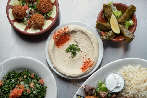 Preview: Top view of hummus, dolma and some Asian dishes on the side