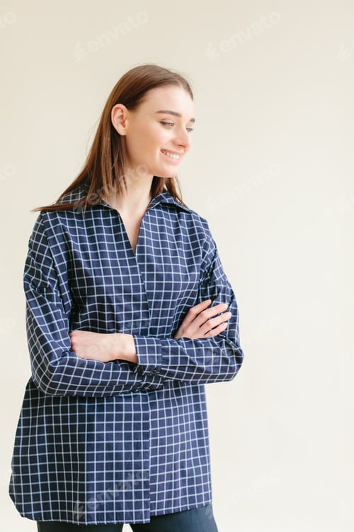 Preview: Smiling Woman Wearing Plaid Shirt Posing Indoors
