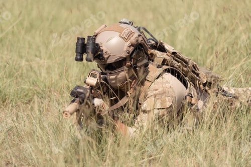 Preview: Special forces soldier in camouflage with a pair of weapons that are full of modern technology