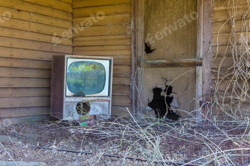 Preview: Old TV set on front porch of an abandoned homestead.