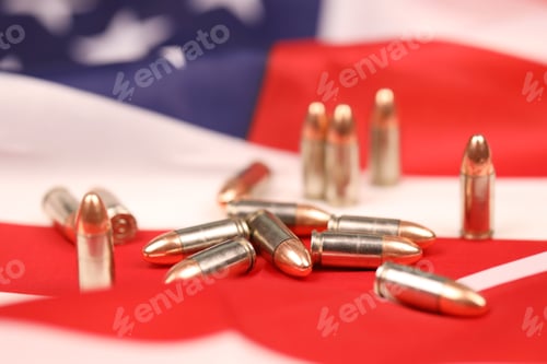 Preview: Many yellow 9mm bullets and cartridges on United States flag