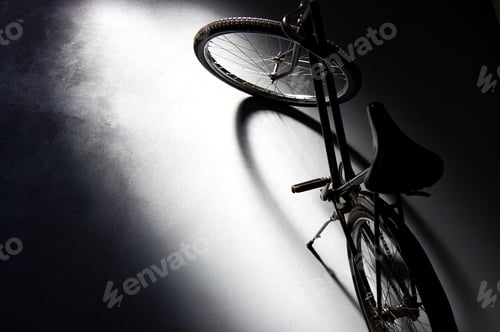 Preview: High angle shot of a vintage bicycle parked in a dark garage