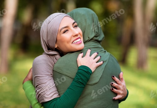 Preview: Two Multiracial Islamic Ladies Hugging Posing Standing Outdoors