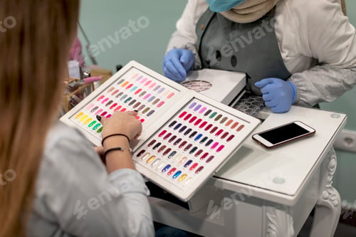 Preview: Nail stylist decorating customer's fingernails