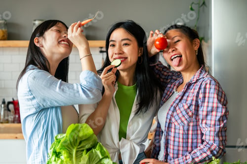 Preview: Happy beautiful chinese women friends bonding at home