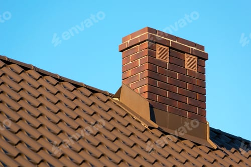 Preview: Brick chimney on the roof and blue sky