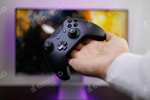 Preview: There's a video game controller on the palm of your hand. Video game gamepad in hand