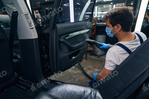 Preview: Specialist doing steam cleaning to handle of car side door