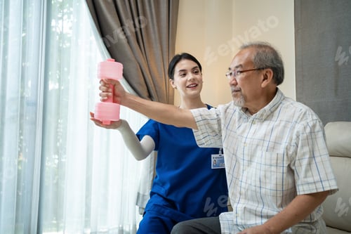 Preview: Caregiver Asian Therapist woman serve physical therapy for older patient exercise with dumbbell