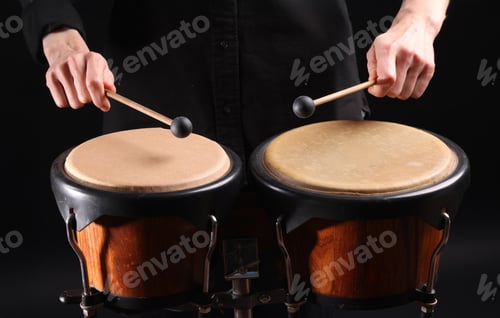 Preview: Drummer playing drums, different percussive musical instruments on a black background.
