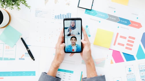 Preview: young Asia businesswoman using phone talk to colleague about plan in video call meeting.