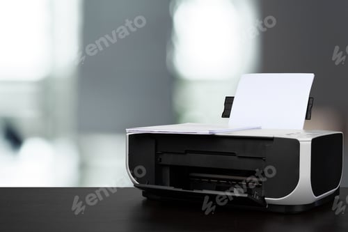 Preview: Compact laser printer on black desk against blurred background