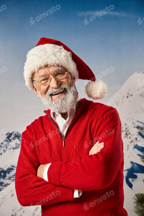 Preview: happy white bearded man looking cheerfully at camera with arms crossed on chest, winter concept