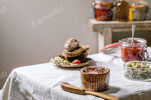 Preview: Ceramic bowl of homemade chicken liver pate with wooden knife