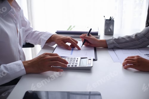 Preview: Two businesspeople accountant coworker work in office consulting meeting brainstorming