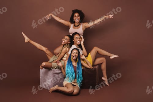 Preview: Young black four women laughing while making fun together