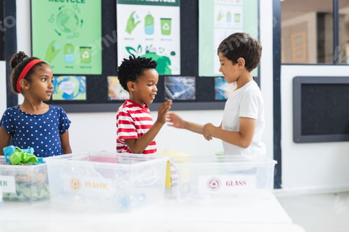 Preview: In school, diverse group of young students learning about recycling in classroom
