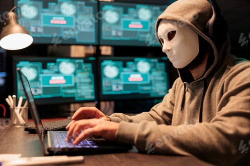 Vista previa: Impostor with mask hacking computer network at night