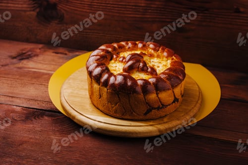 Preview: Delicious homemade cake displayed on a wooden board in a cozy setting