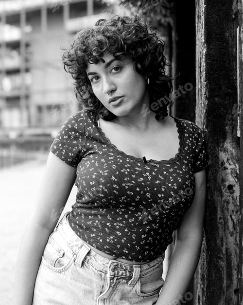 Preview: Young woman posing in urban setting, monochrome medium format film portrait