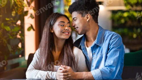 Preview: Young Couple Enjoying a Romantic Moment at a Cafe