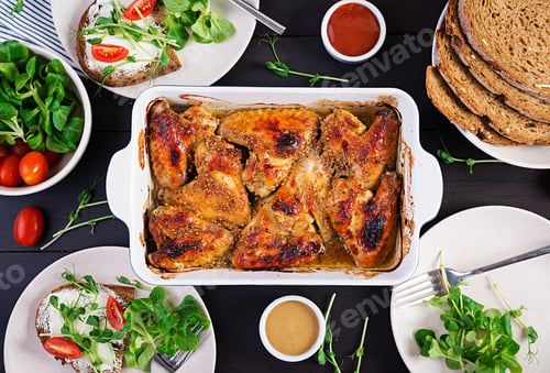 Preview: Grilled chicken wings. Baked chicken wings on wooden table.
