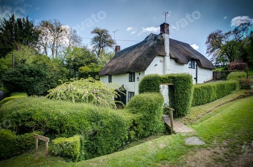 Preview: Shot of a magical white cottage with a thatched roof