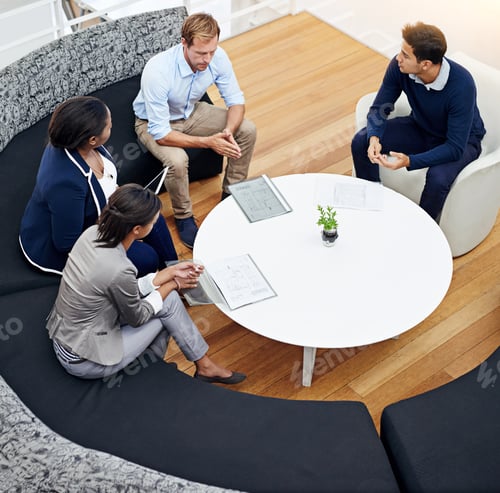Preview: High angle shot of a group of colleagues having a meeting in a modern office
