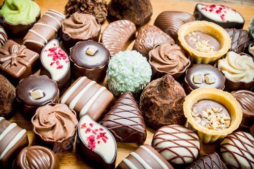 Preview: Chocolate candies with nuts and various fillings.