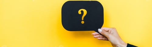 Preview: panoramic shot of woman holding black speech bubble with question mark on orange