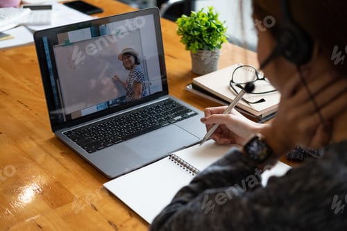 Preview: Woman Learns Online with Teacher on Laptop Screen