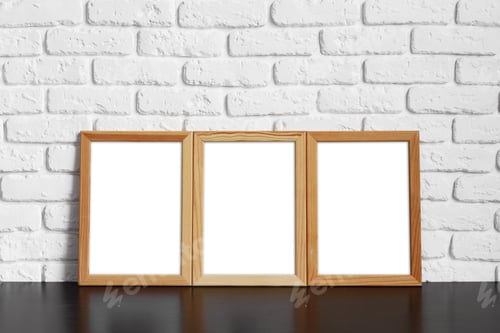 Preview: Blank picture frame against brick wall with copy space