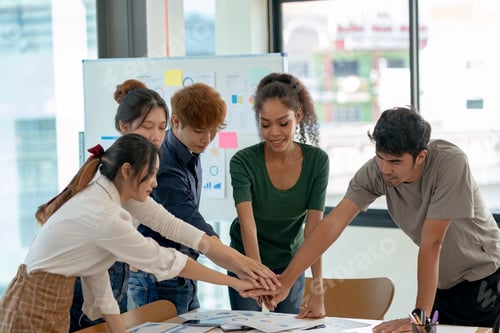 Preview: Young Asian business people shaking hands and working together as a team and having unity in working