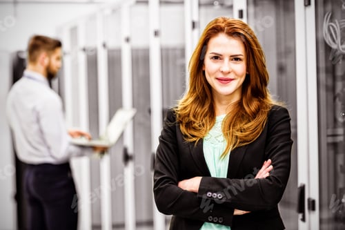 Preview: Professional Woman in Server Room With Colleague