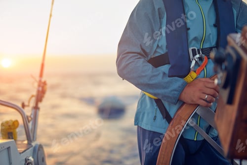 Preview: Sailor Using Wheel To Steer Rudder On A Sailing Boat.