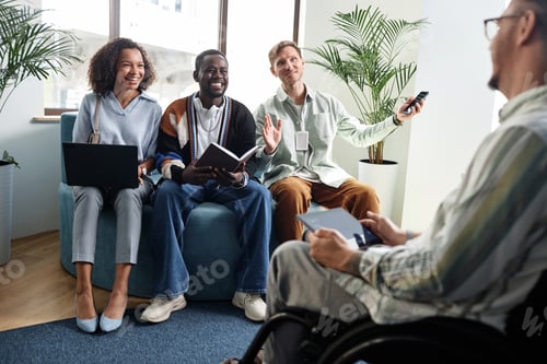 Preview: Colleagues planning work together at meeting