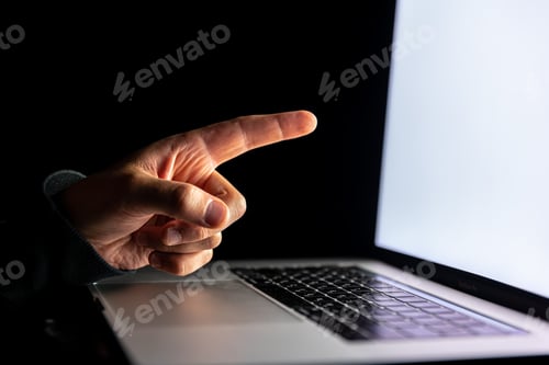Preview: Close-up of a finger points to a laptop screen.