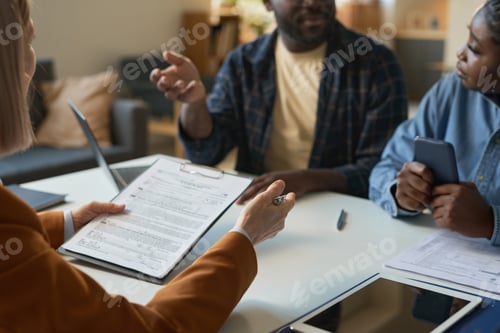 Preview: Closeup of Woman Holding Clipboard Consulting Family