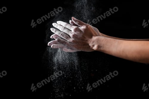 Preview: close-up partial view of sportswoman applying talcum powder on hands isolated on black