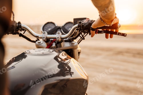 Preview: Mature man wearing black t-shirt with tattoo posing on motorbike